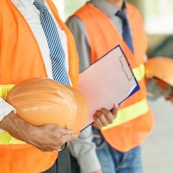 Cropped image of engineers with orange hard has ready to work